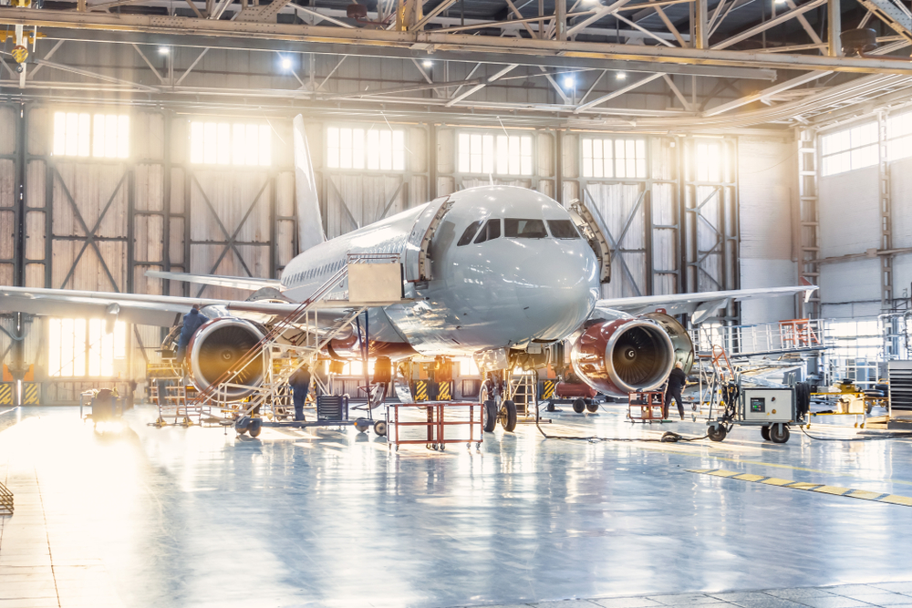 Same day aviation courier services by Transol Sameday - commercial aircraft undergoing maintenance in a professional aviation hangar