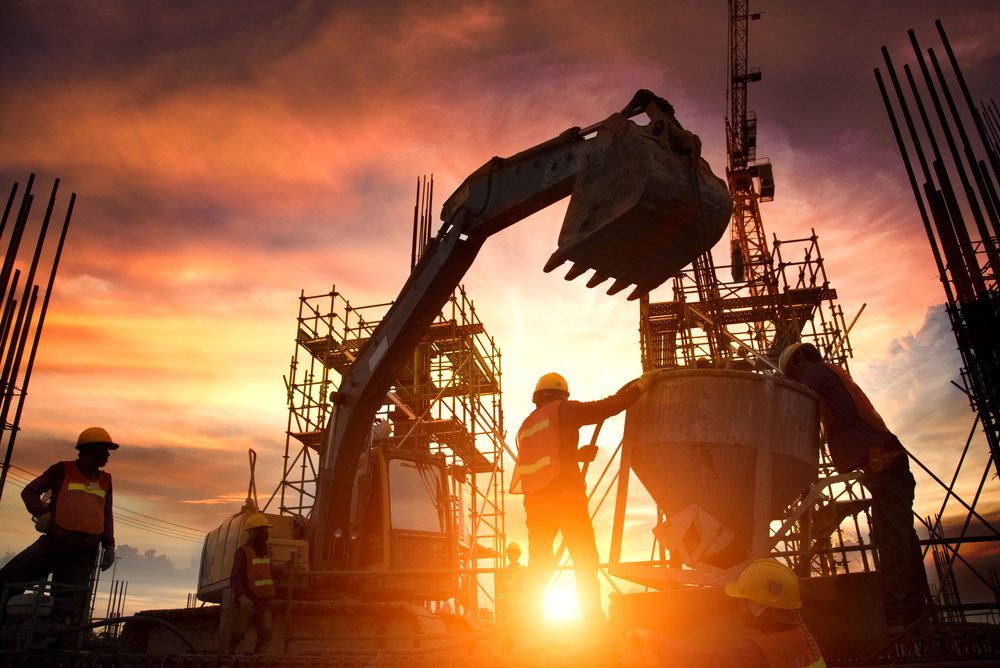 Same day manufacturing courier services by Transol Sameday - industrial workers operating heavy machinery at a construction site