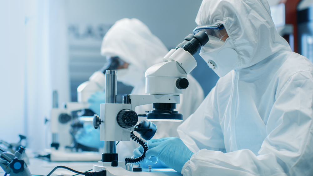 Same day pharmaceutical and medical courier services by Transol Sameday - scientists in cleanroom suits conducting research in a sterile laboratory