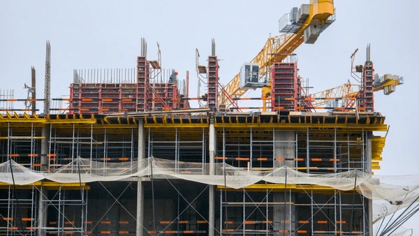 Same day construction courier services by Transol Sameday - multi-storey building under construction with scaffolding, formwork and tower crane at an active building site